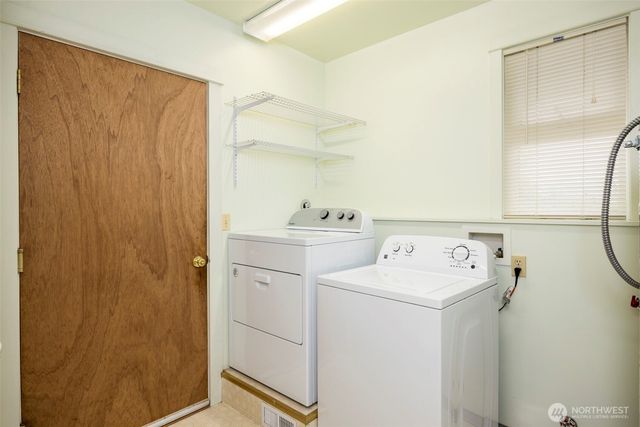 a view of a house with backyard and trees