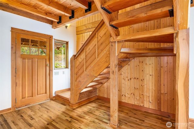 a view of entryway and hall with wooden floor