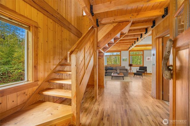 a living room with furniture and floor to ceiling windows