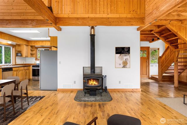 a living room with furniture a rug a fireplace and a floor to ceiling window