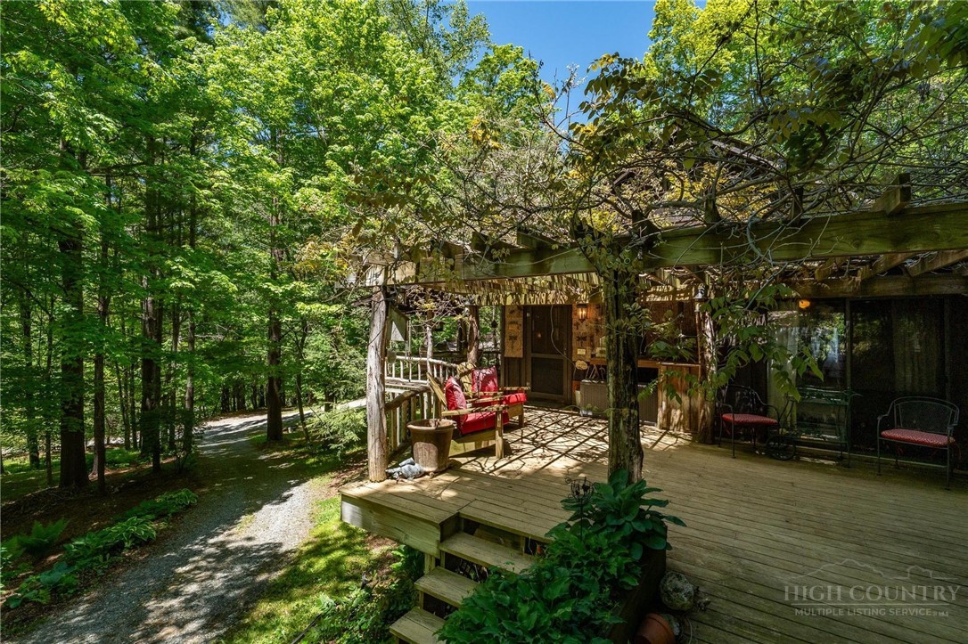 165 Natures Way Boone, NC 28607 - Photo 45 of 50 a view of a patio with table and chairs potted plants and large tree