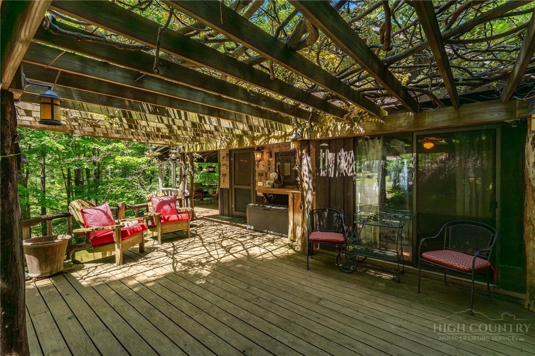 165 Natures Way Boone, NC 28607 - Photo 47 of 50 a view of a chairs and table in a patio with wooden fence