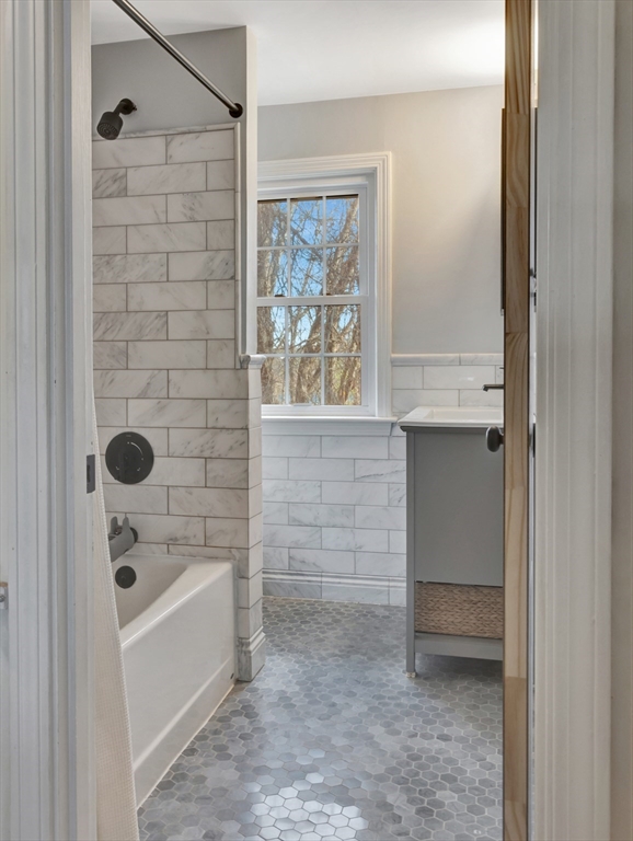 57 Clough Road, Unit 57 Dedham, MA 02026 - Photo 13 of 24 a bathroom with a bathtub and shower