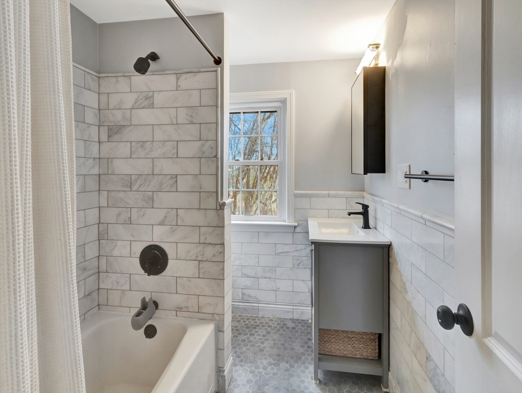 57 Clough Road, Unit 57 Dedham, MA 02026 - Photo 14 of 24 a bathroom with a tub sink and mirror