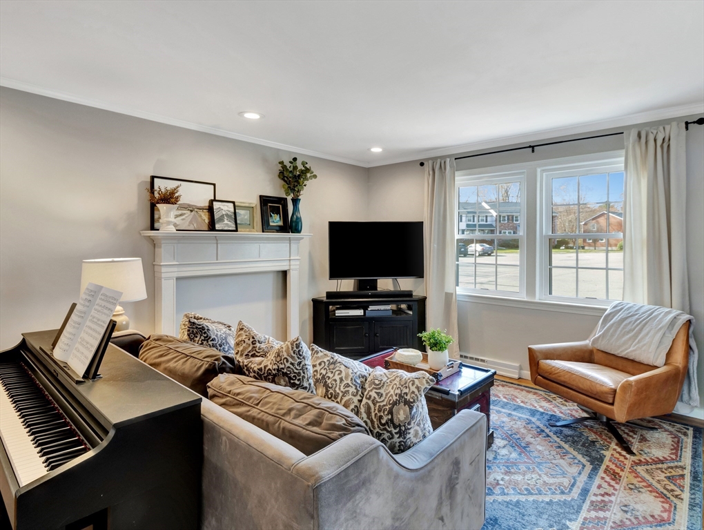57 Clough Road, Unit 57 Dedham, MA 02026 - Photo 5 of 24 a living room with furniture a flat screen tv and a large window