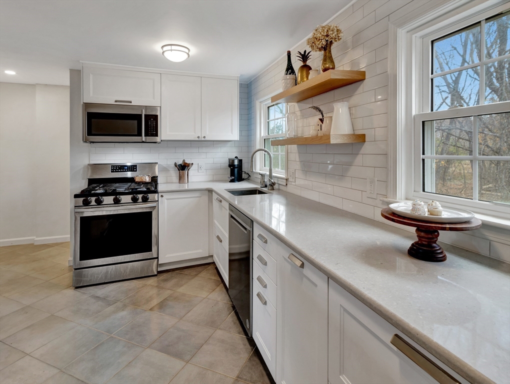 57 Clough Road, Unit 57 Dedham, MA 02026 - Photo 8 of 24 a kitchen with a sink a stove and cabinets
