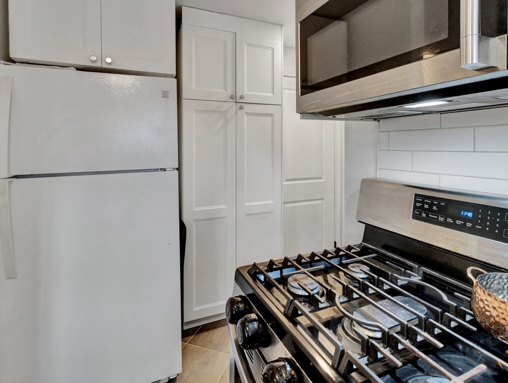 57 Clough Road, Unit 57 Dedham, MA 02026 - Photo 9 of 24 a stove top oven sitting inside of a kitchen