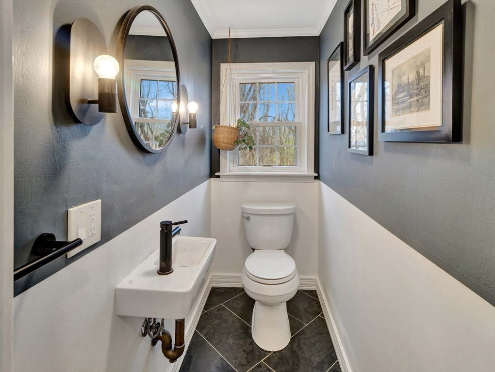 57 Clough Road, Unit 57 Dedham, MA 02026 - Photo 10 of 24 a bathroom with a toilet a sink and mirror