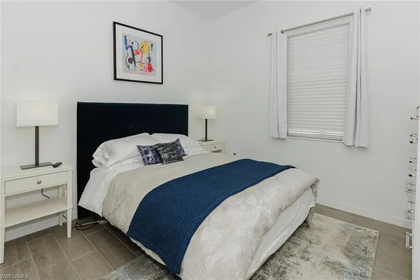 a bedroom with a bed and a night stand