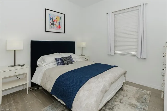 a bedroom with a bed and a night stand