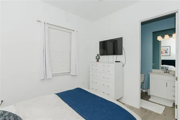 a room with a dresser and flat screen tv