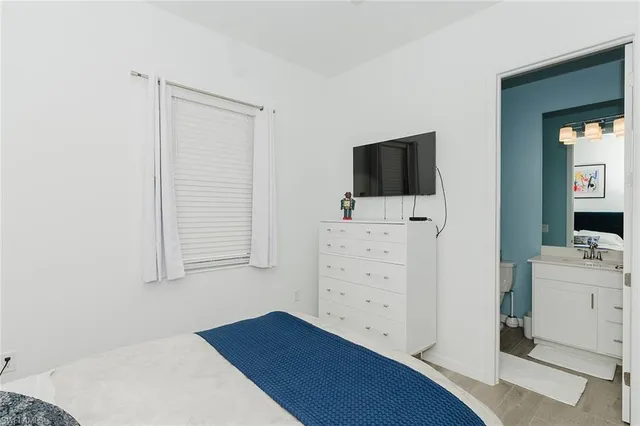 a room with a dresser and flat screen tv