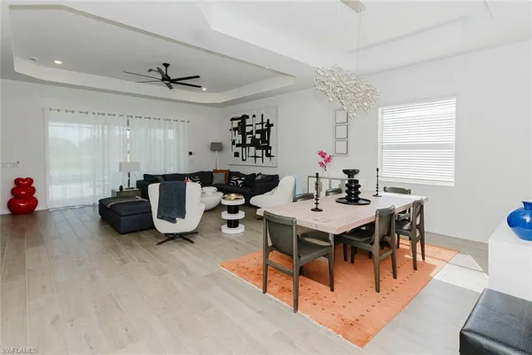 a view of a dining room with furniture and a chandelier