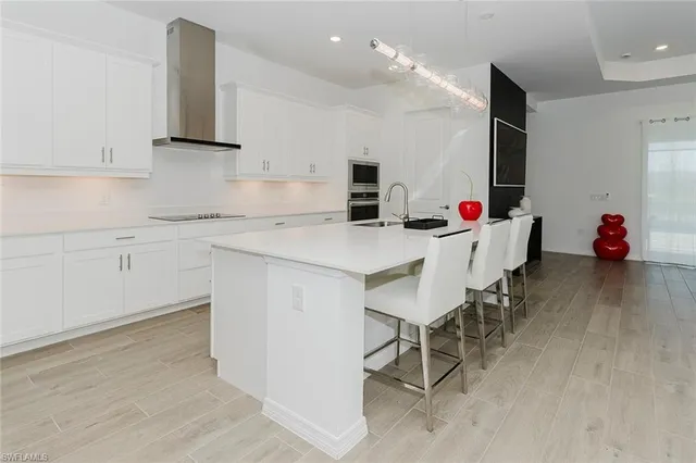 a kitchen with a sink cabinets and wooden floor