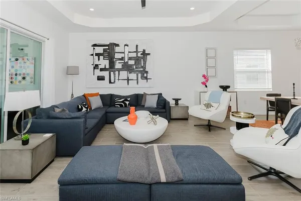 a living room with furniture and flowers