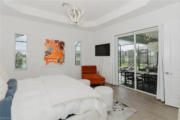 a bedroom with furniture and a flat screen tv