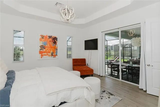 a bedroom with furniture and a flat screen tv