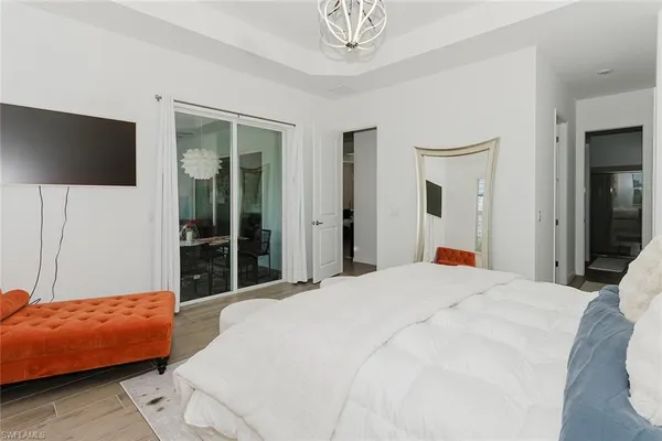 a bedroom with a bed and a flat screen tv