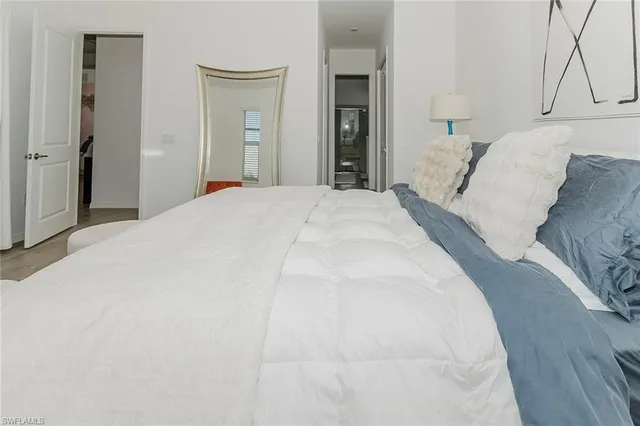 a bedroom with a bed and a mirror