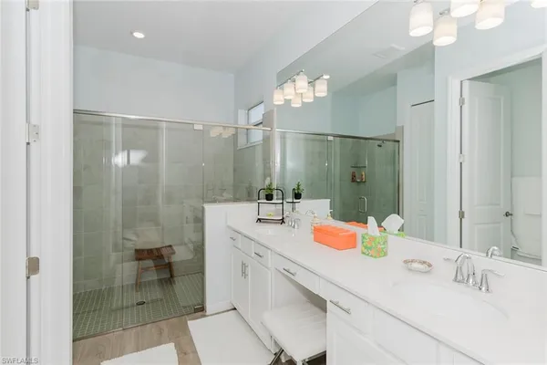 a bathroom with a double vanity sink mirror and double