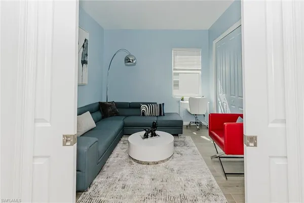 a living room with furniture and a mirror