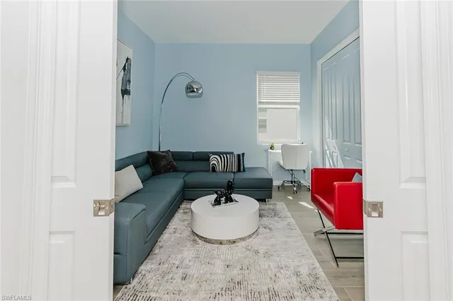 a living room with furniture and a mirror