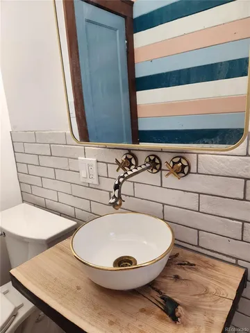 a view of a hallway with wooden floor and glass door