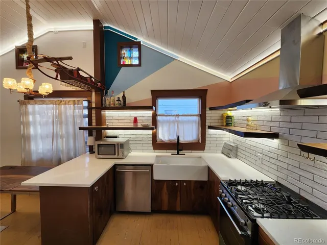 a kitchen with a sink a stove and cabinets