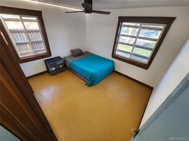 a view of a room with wooden floor and cabinet