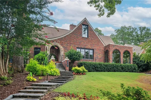 a front view of house with yard and green space