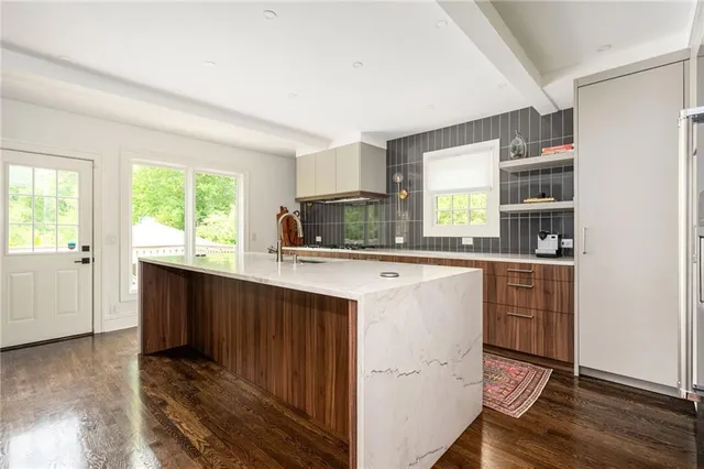 a view of swimming pool with outdoor seating and wooden floor