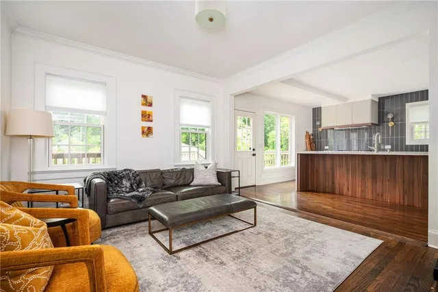 a view of an empty room with wooden floor