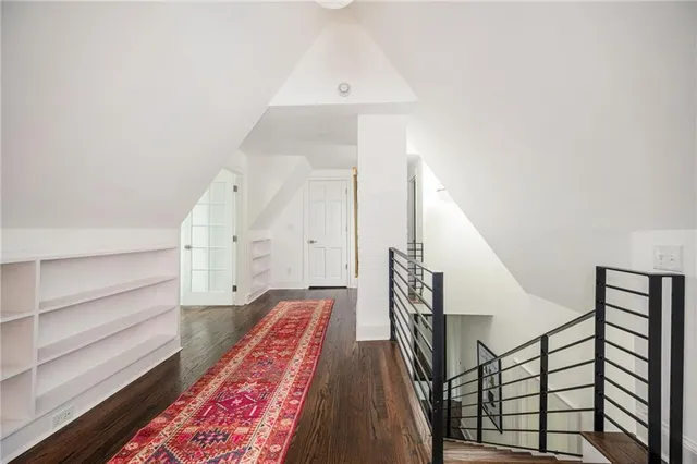 a white bath tub with window and a potted plant