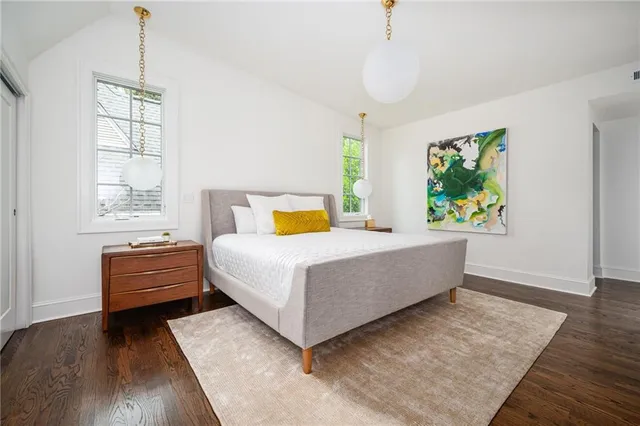 a spacious bathroom with a granite countertop sink a toilet and shower
