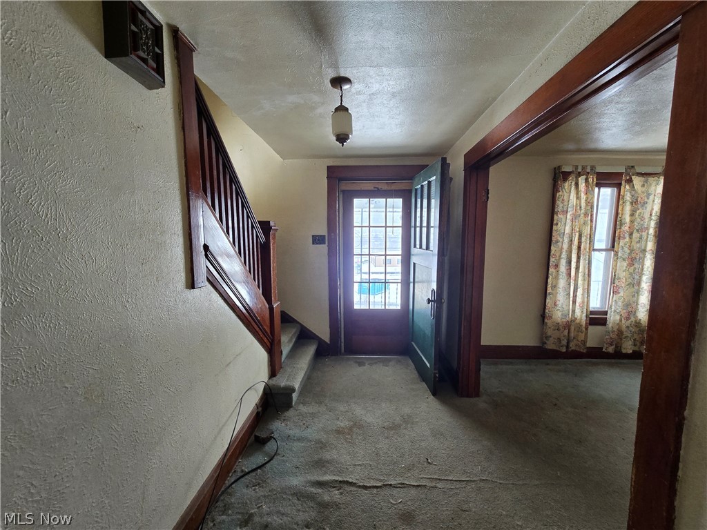 844 National Road Bridgeport, OH 43912 - Photo 5 of 15 Entryway with a textured wall, a textured ceiling, and carpet