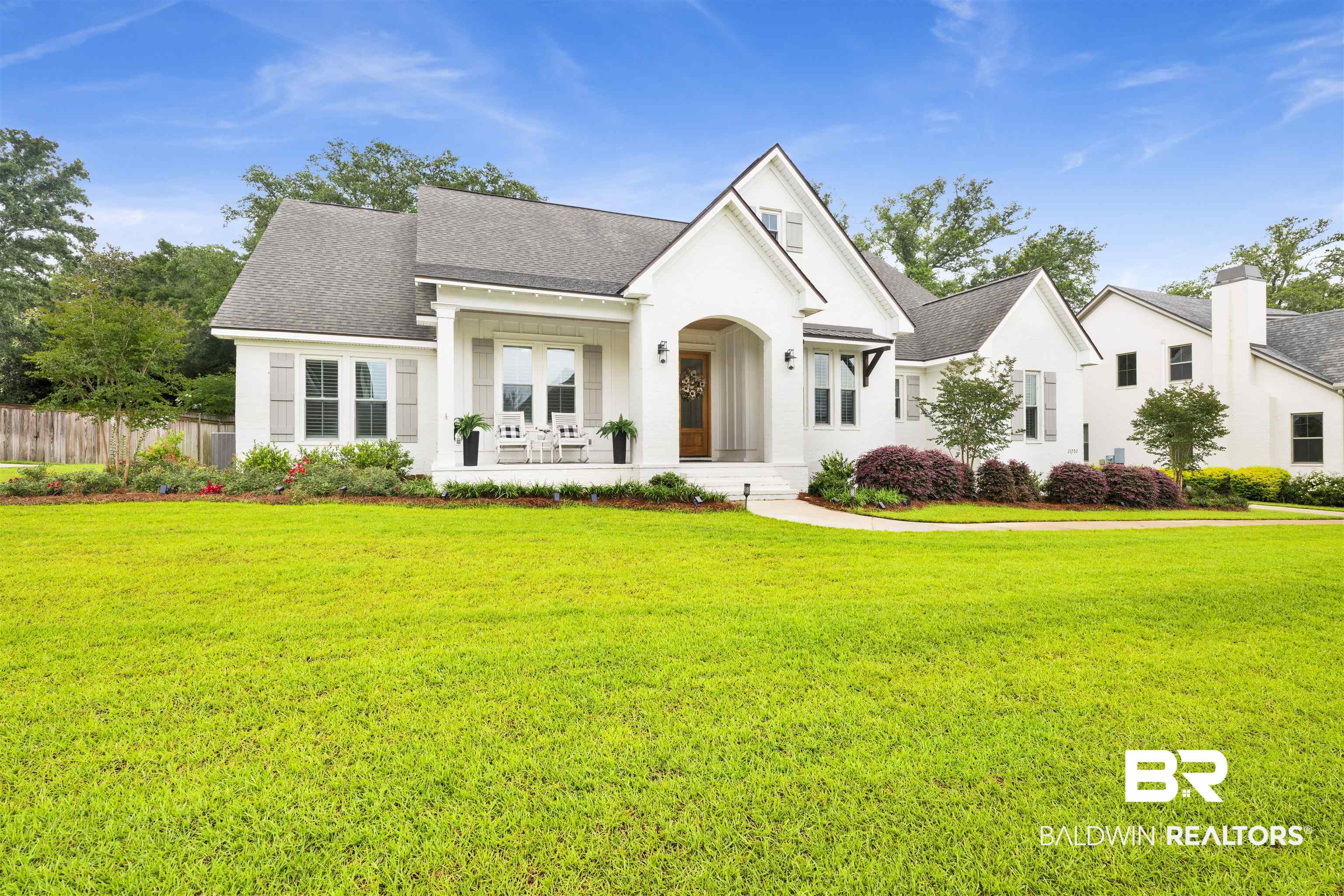 21702 Pillars Street Fairhope, AL 36532 - Photo 52 of 54 White exterior featuring dark shingle roofing and an expansive front lawn