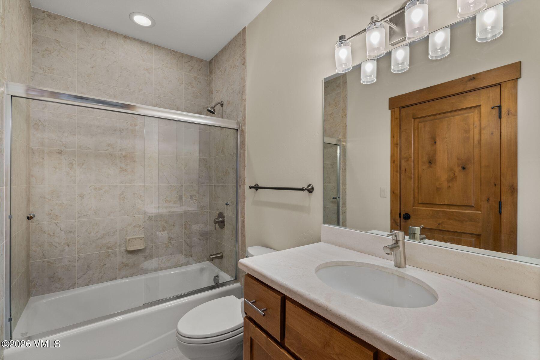 1015 West Wildwood Road, Unit F Avon, CO 81620 - Photo 15 of 35 a bathroom with a sink a toilet and shower