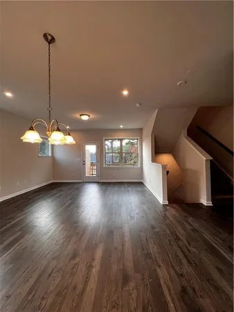 a view of a room with window and wooden floor
