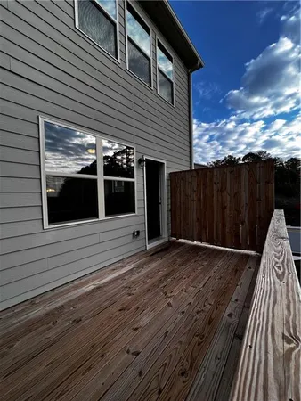 a balcony with wooden floor and fence
