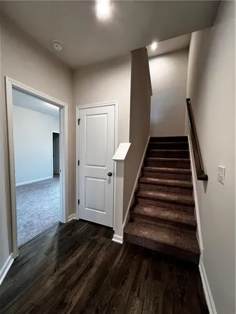 a view of entryway and hall with wooden floor