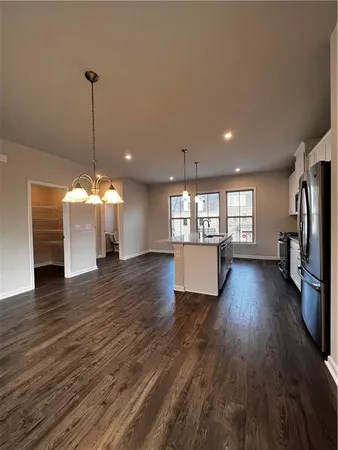 a view of a room wooden floor and windows