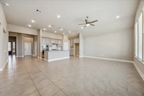 a view of a kitchen with a sink and a refrigerator