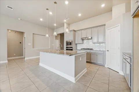 a kitchen with a sink counter top space appliances and cabinets