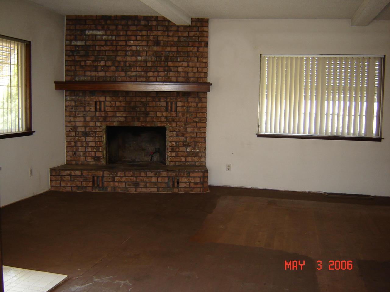 2411 Duffield Road Moxee, WA 98936 - Photo 4 of 13 a living room with a fireplace and a wooden floor