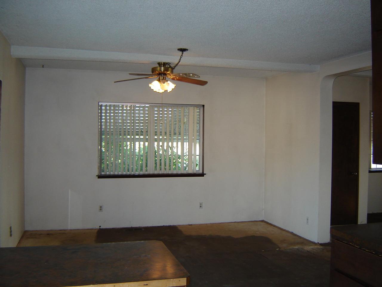 2411 Duffield Road Moxee, WA 98936 - Photo 6 of 13 an empty room with wooden floor a chandelier fan and windows