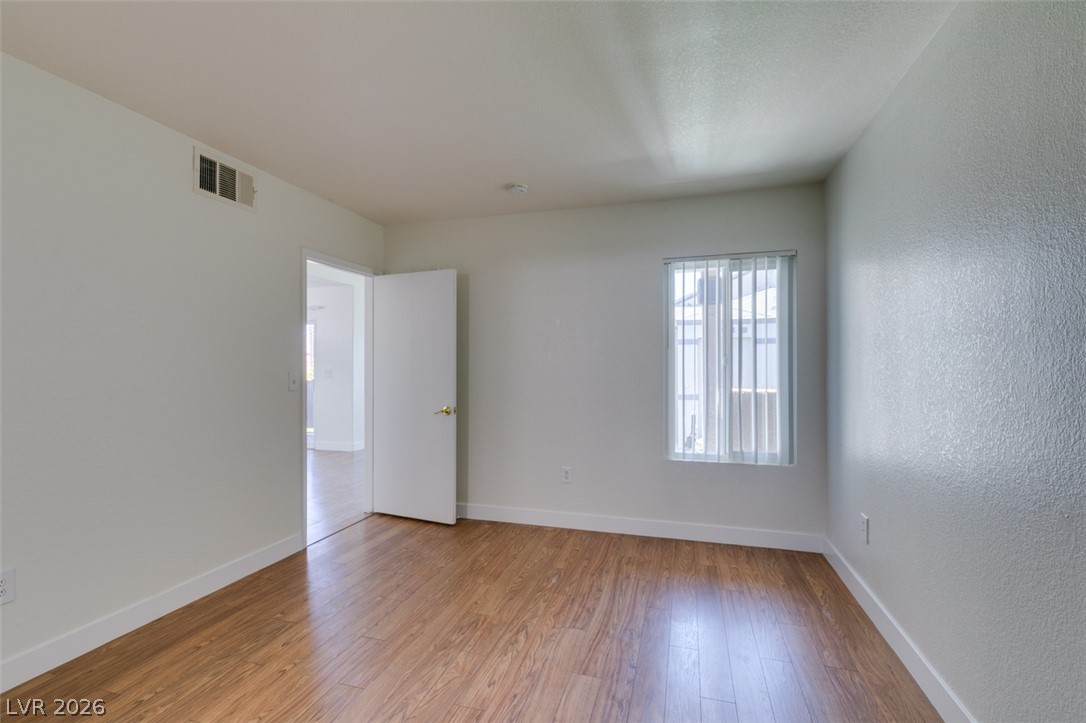 6650 West Warm Springs Road, Unit 2118 Las Vegas, NV 89118 - Photo 17 of 41 Natural light illuminates the rich hardwood-style flooring in this versatile room.