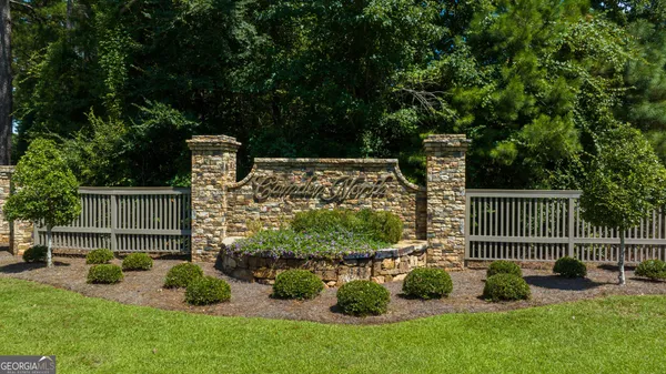 a swimming pool with a yard and large trees