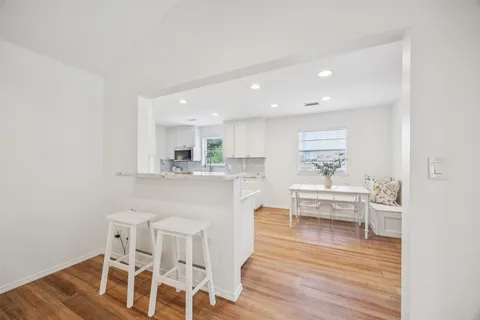 a living room with wooden floor and furniture