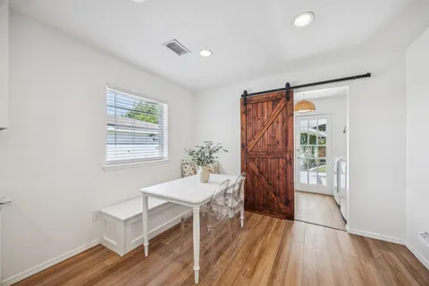 a view of a bedroom with wooden floor and a window