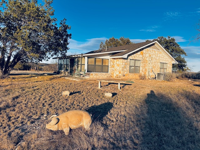 810 Kc 271 Junction Junction, TX 76849 - Photo 5 of 20 View of property exterior featuring stone siding and a sunroom